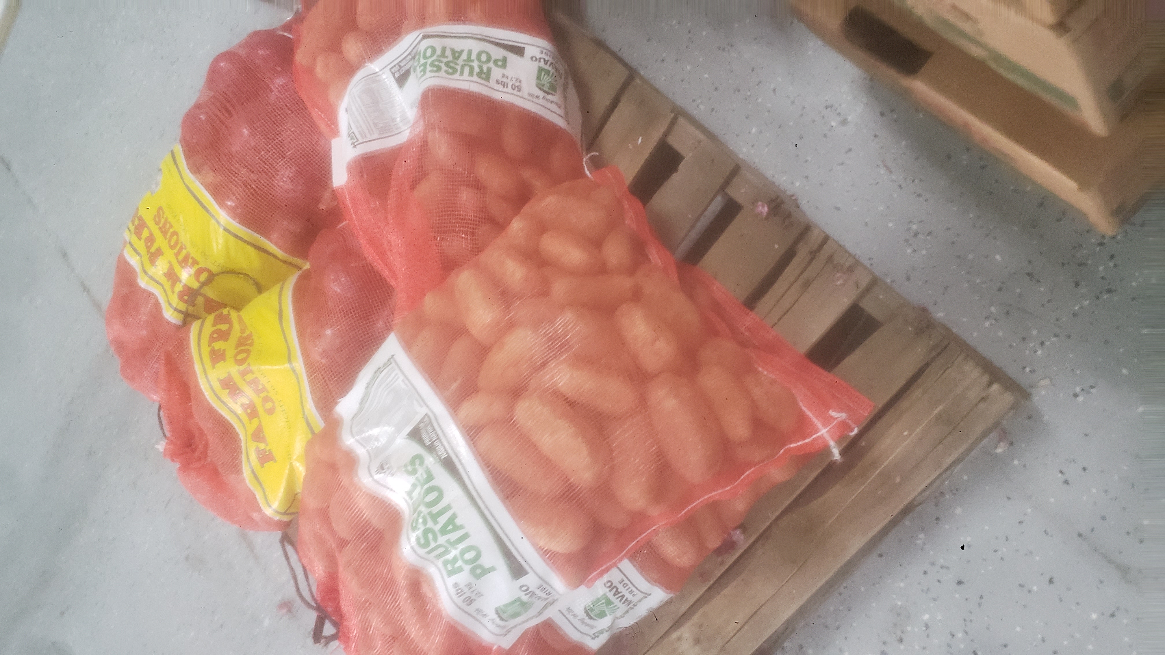 Bulk bags of potatoes on pallet.